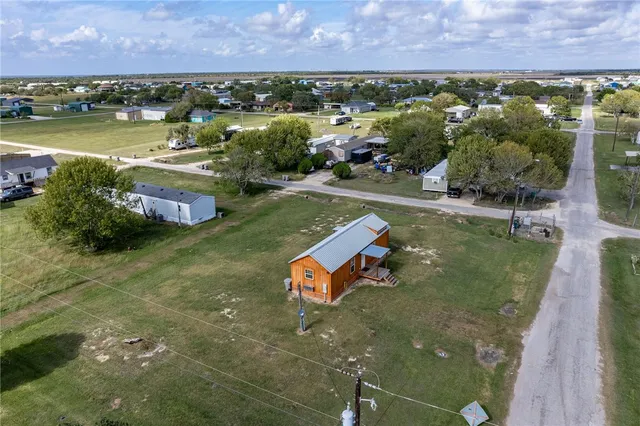 aerial view of a house with a yard