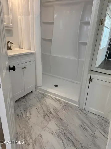 a bathroom with a sink and a shower