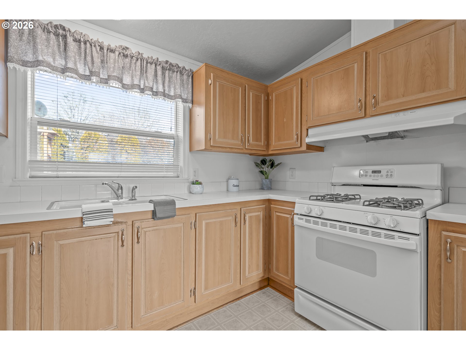 860 West Ellendale Avenue Dallas, OR 97338 - Photo 22 of 33 a kitchen with cabinets appliances a sink and a window