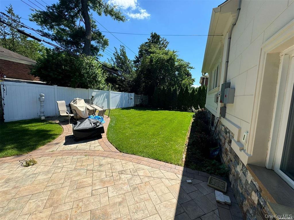 830 Pepperidge Road Westbury, NY 11590 - Photo 14 of 15 a view of a garden with chair and bench