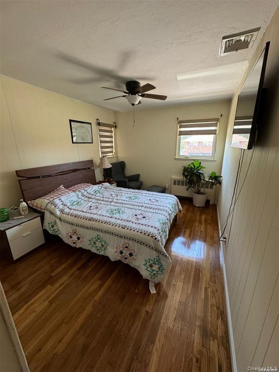 830 Pepperidge Road Westbury, NY 11590 - Photo 15 of 15 a bedroom with a bed and wooden floor