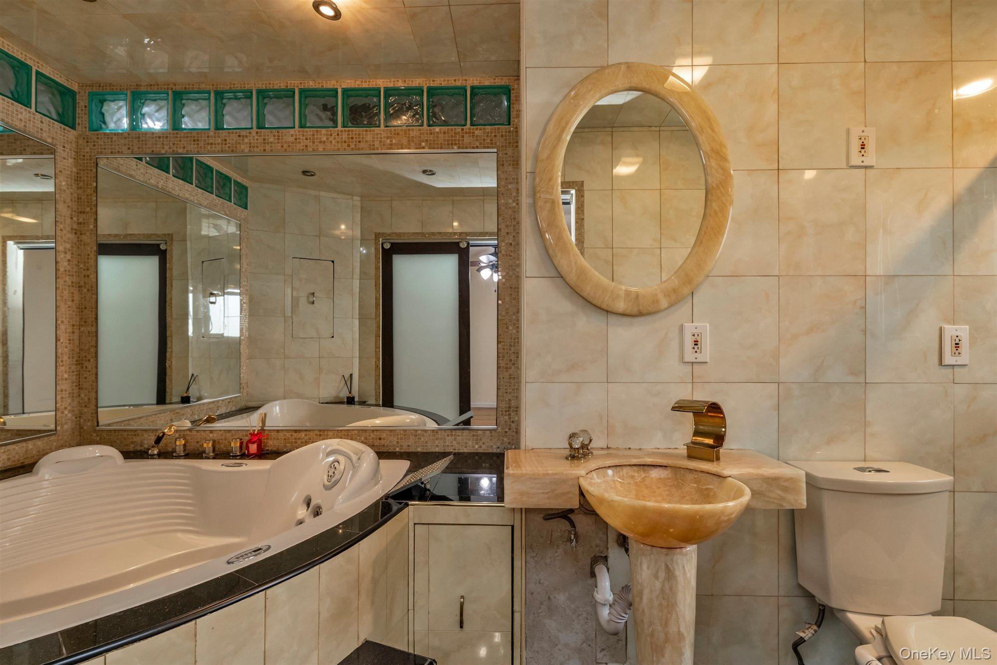 830 Pepperidge Road Westbury, NY 11590 - Photo 15 of 23 a bathroom with a sink and a mirror