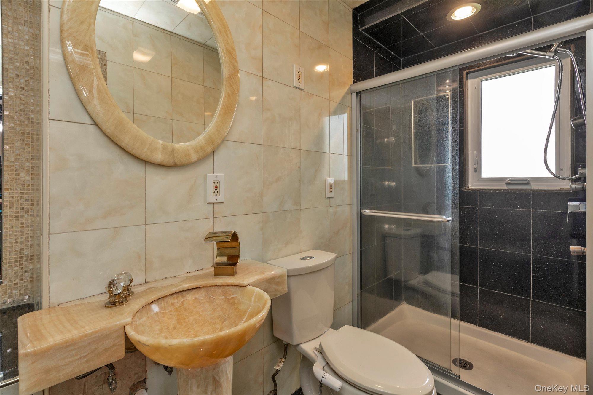 830 Pepperidge Road Westbury, NY 11590 - Photo 16 of 23 a bathroom with a sink a toilet and shower