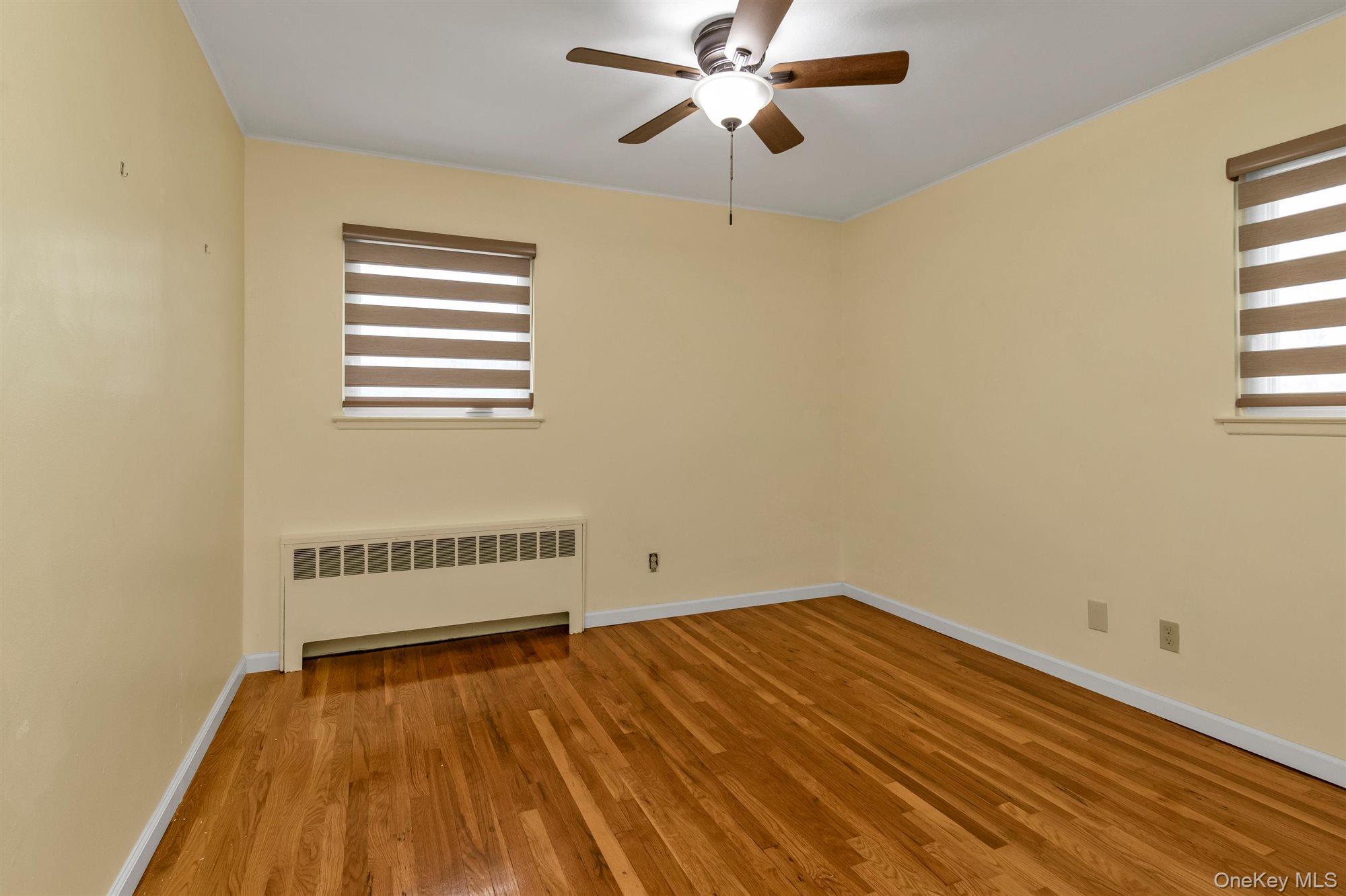 830 Pepperidge Road Westbury, NY 11590 - Photo 17 of 23 a view of a room with wooden floor and fan