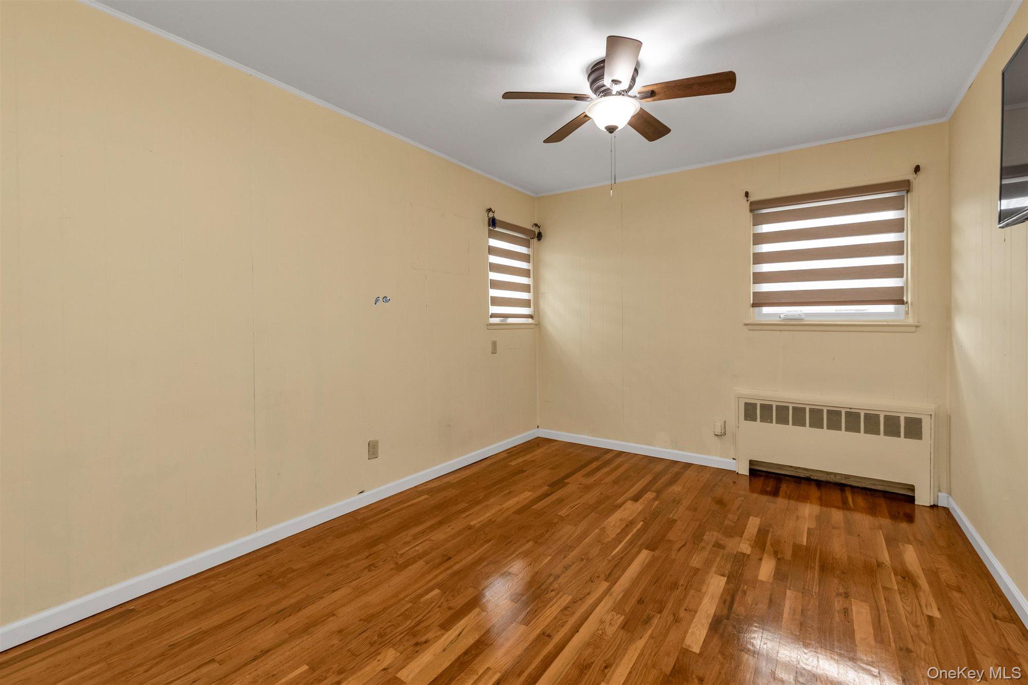830 Pepperidge Road Westbury, NY 11590 - Photo 19 of 23 a view of empty room with wooden floor and fan