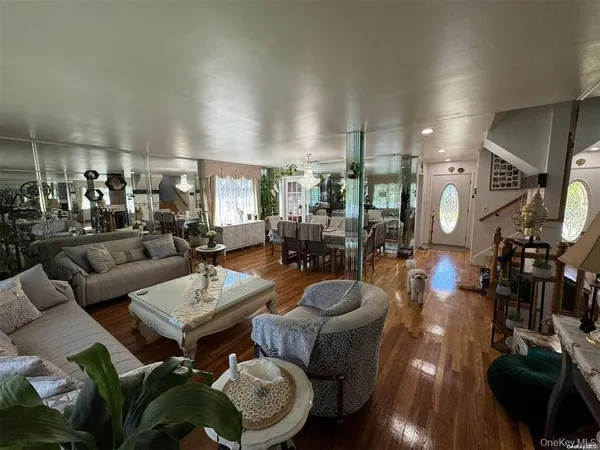a living room with lots of furniture and wooden floor