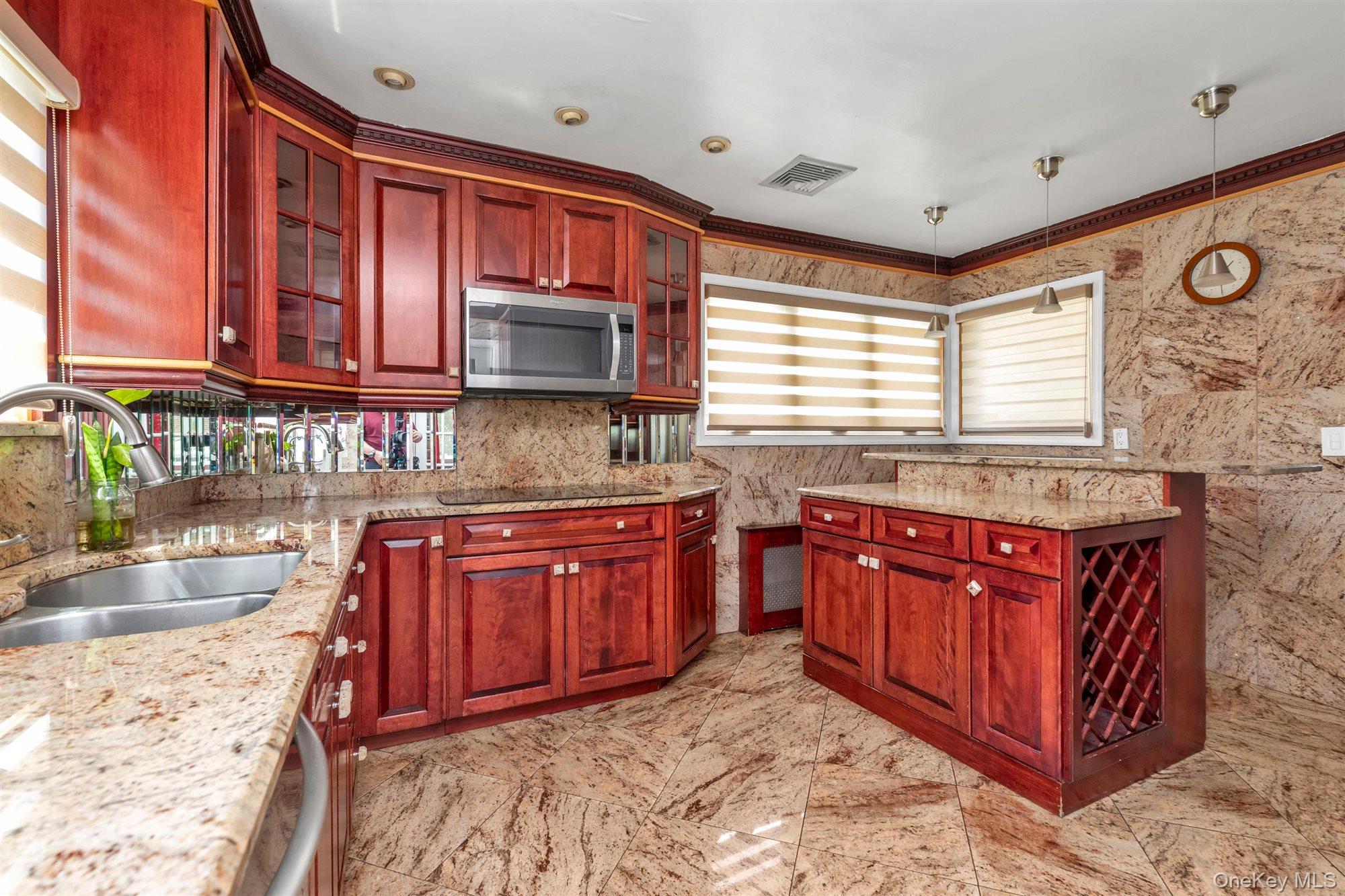 830 Pepperidge Road Westbury, NY 11590 - Photo 7 of 23 a kitchen with stainless steel appliances granite countertop wooden cabinets a granite counter tops and a large window