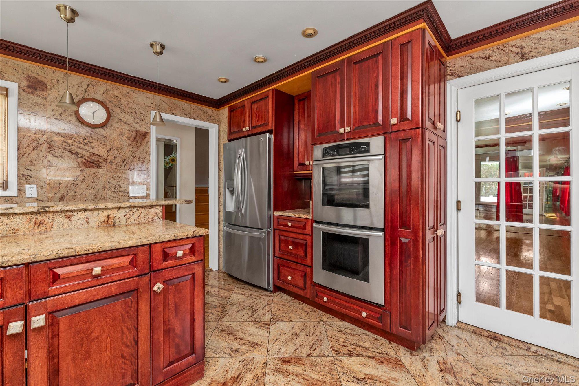 830 Pepperidge Road Westbury, NY 11590 - Photo 8 of 23 a kitchen with stainless steel appliances granite countertop a refrigerator and a stove top oven