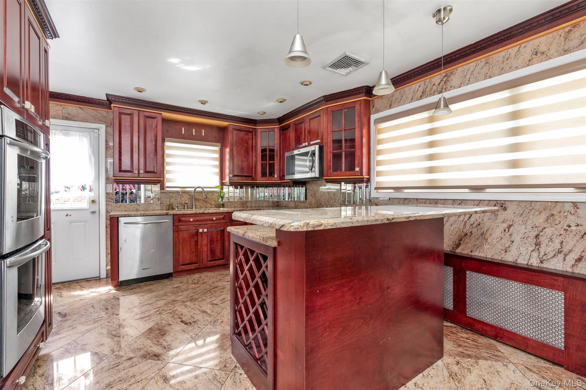 830 Pepperidge Road Westbury, NY 11590 - Photo 9 of 23 a kitchen with stainless steel appliances granite countertop a stove a sink and a refrigerator