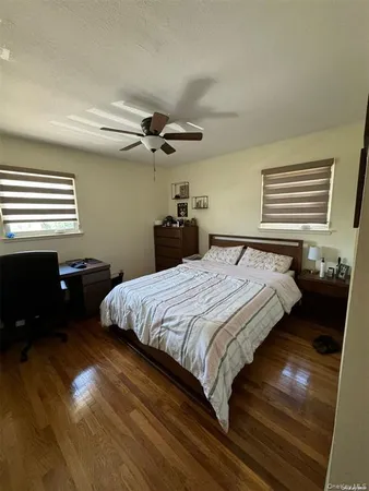 a bedroom with a bed and a ceiling fan