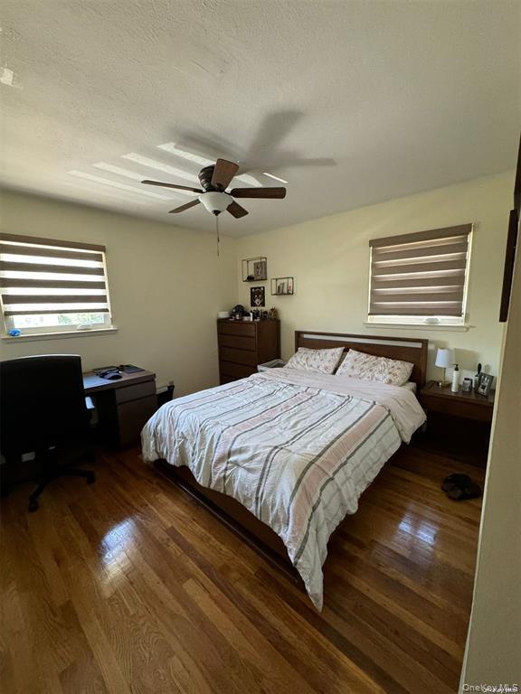 830 Pepperidge Road Westbury, NY 11590 - Photo 10 of 15 a bedroom with a bed and a ceiling fan