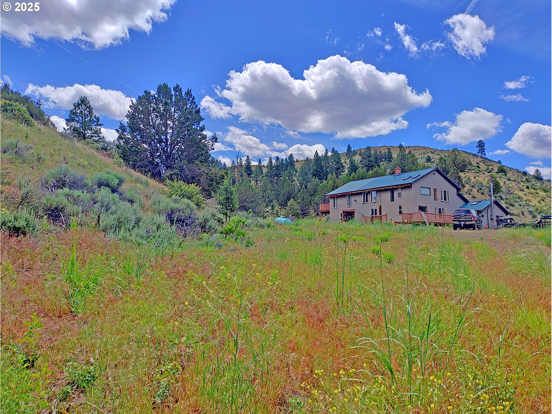 12142 Burns-Izee Road Seneca, OR 97873 - Photo 4 of 40 a view of a lake with a house in the background