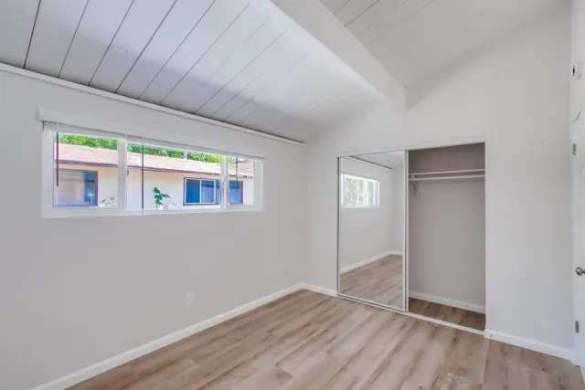 a big room with wooden floor and windows