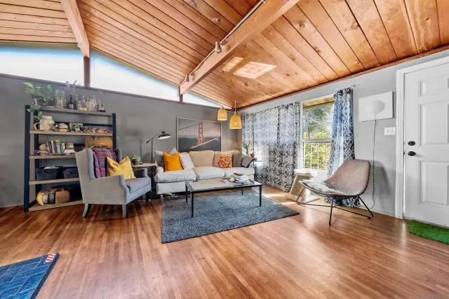 a living room with furniture and wooden floor