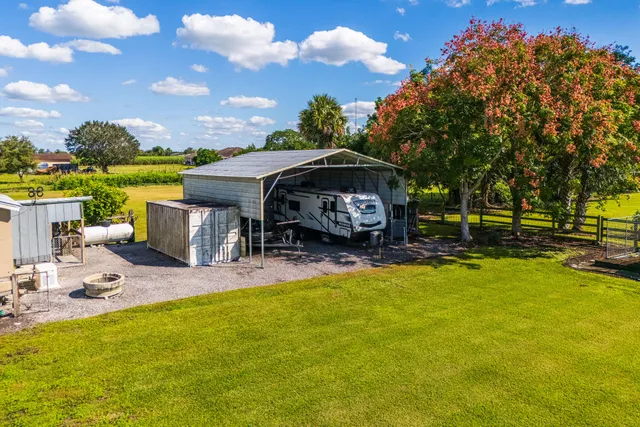 a front view of a house with swimming pool having outdoor seating