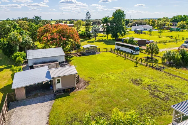 an aerial view of a house with a swimming pool outdoor seating and yard