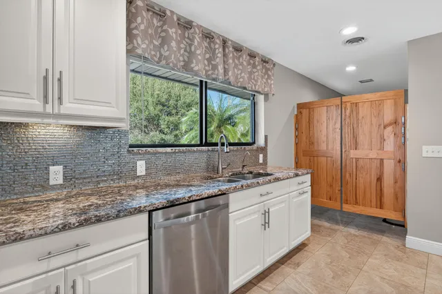 a kitchen with a sink and cabinets