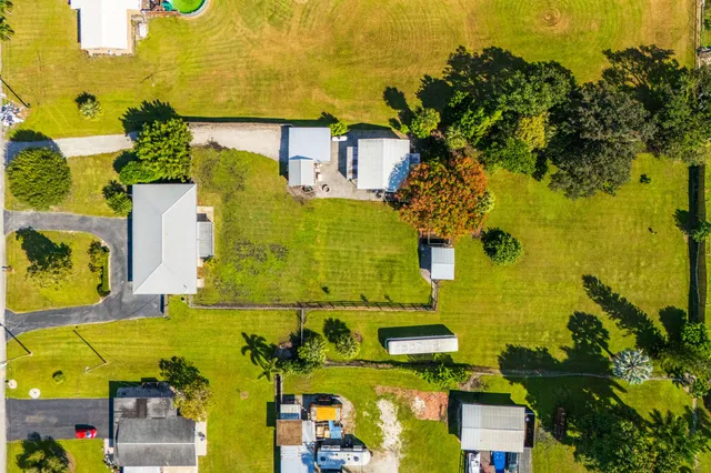 an aerial view of a houses with swimming pool