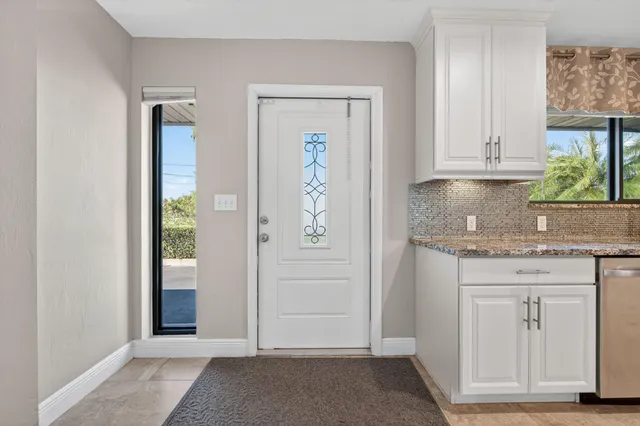 an empty room with cabinet and mirror