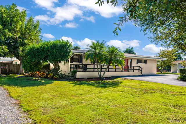 a view of a house with swimming pool and sitting area