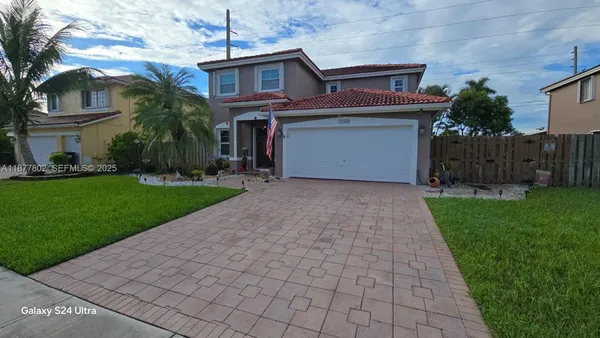 a front view of a house with a yard and garage