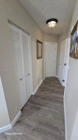 a view of a livingroom with wooden floor and stairs