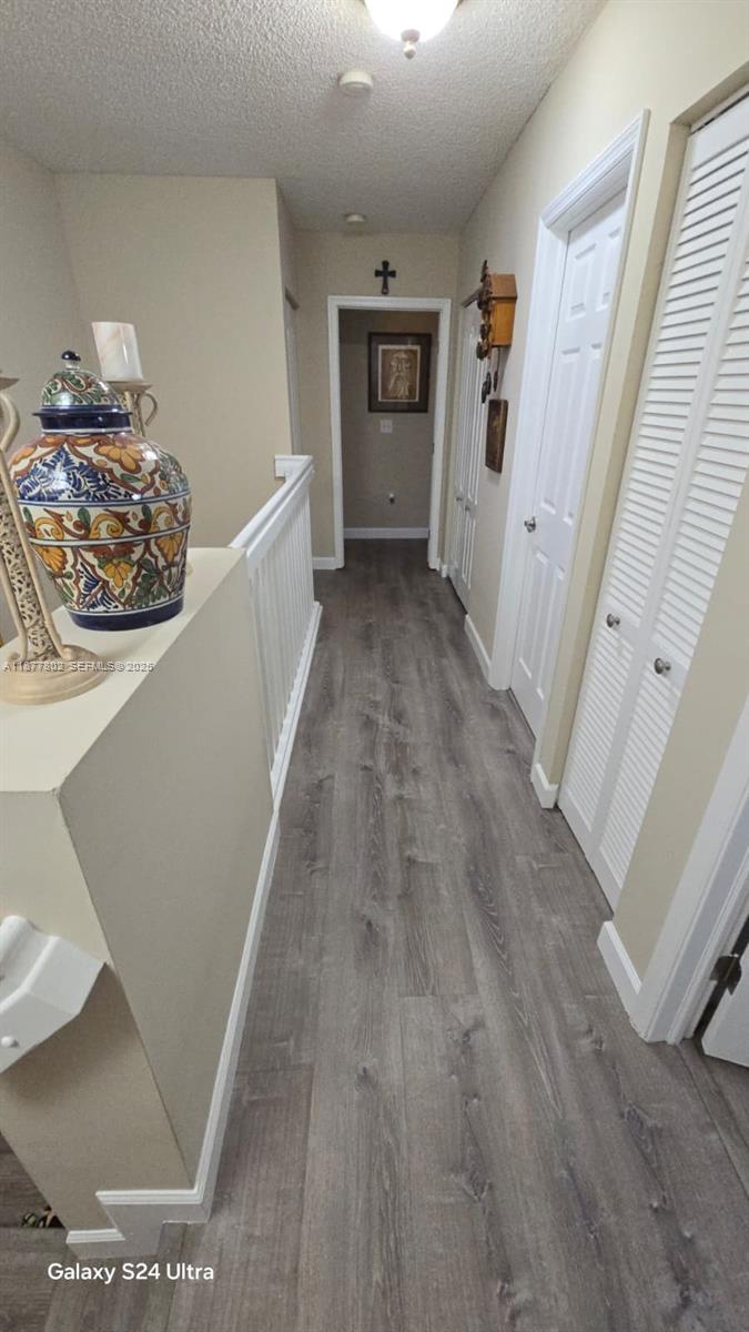 15436 Southwest 151st Terrace Miami, FL 33196 - Photo 13 of 50 a view of a hallway to a livingroom with wooden floor and furniture