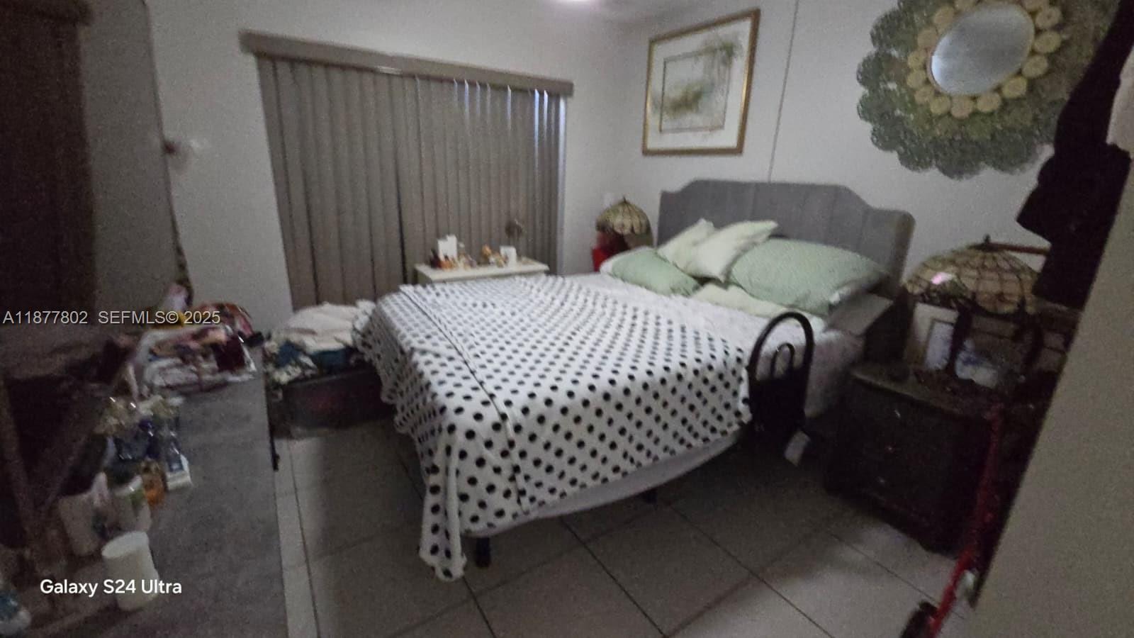 15436 Southwest 151st Terrace Miami, FL 33196 - Photo 14 of 50 a bedroom with a bed and a mirror