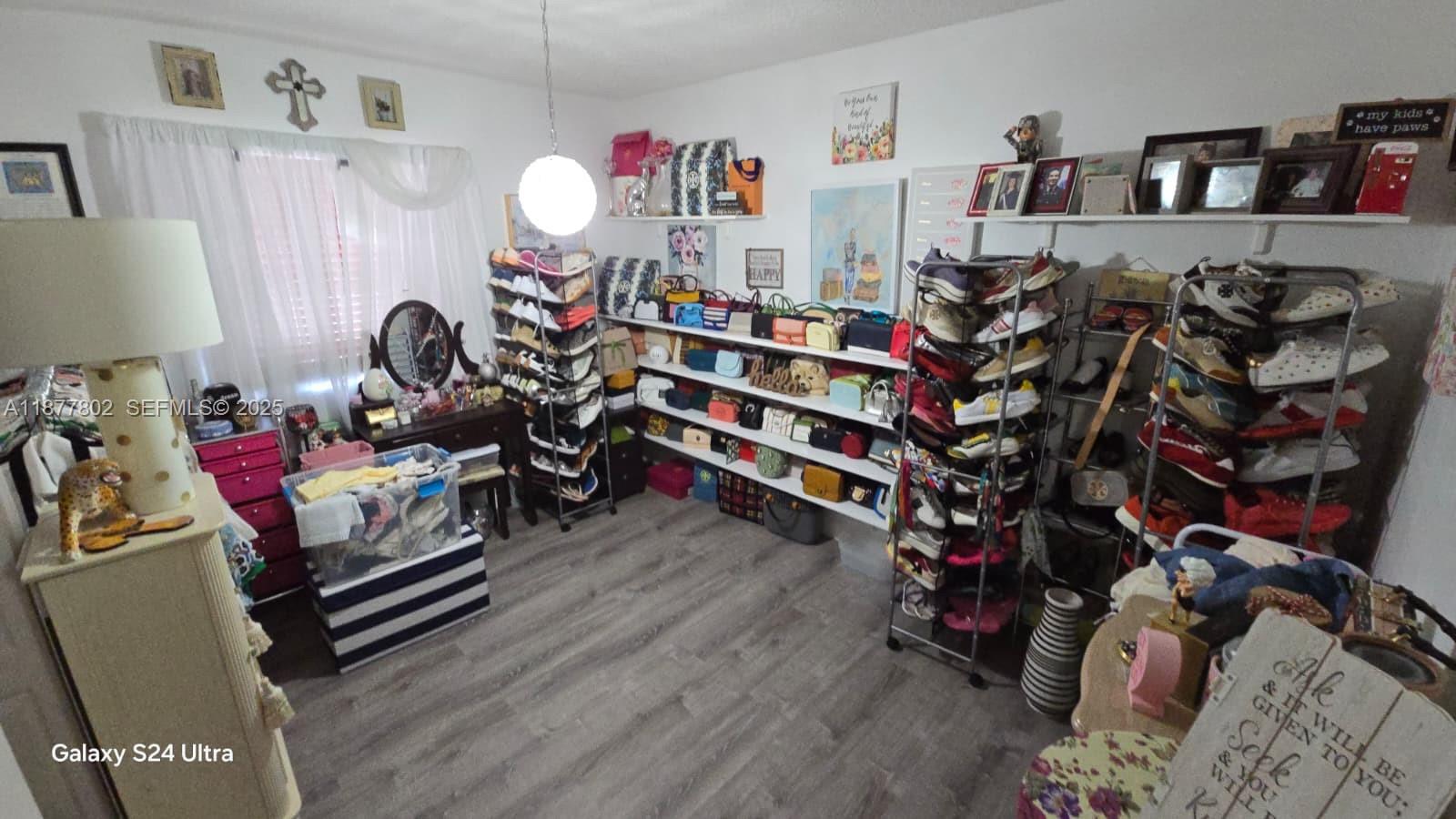 15436 Southwest 151st Terrace Miami, FL 33196 - Photo 18 of 50 a living room with lots of furniture and a wooden floor