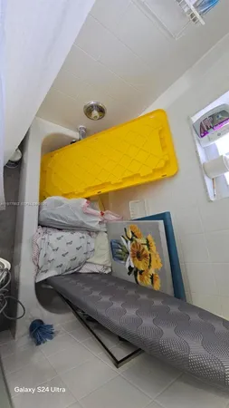a bedroom with a bed and teddy bear on bed