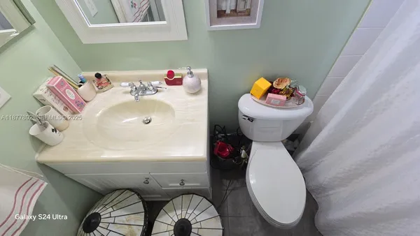 a bathroom with a sink toilet and mirror