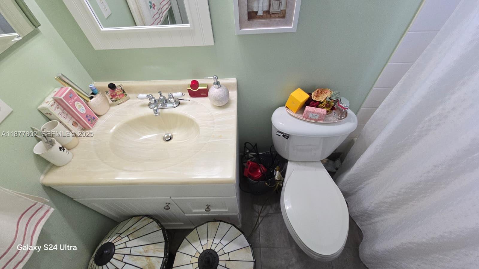 15436 Southwest 151st Terrace Miami, FL 33196 - Photo 26 of 50 a bathroom with a sink toilet and mirror