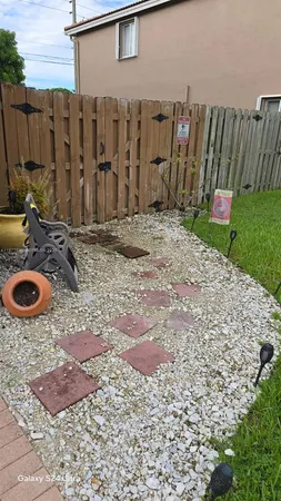 a backyard of a house with barbeque oven