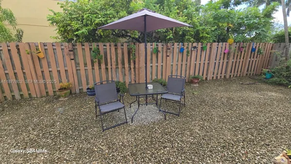 a backyard of a house with table and chairs