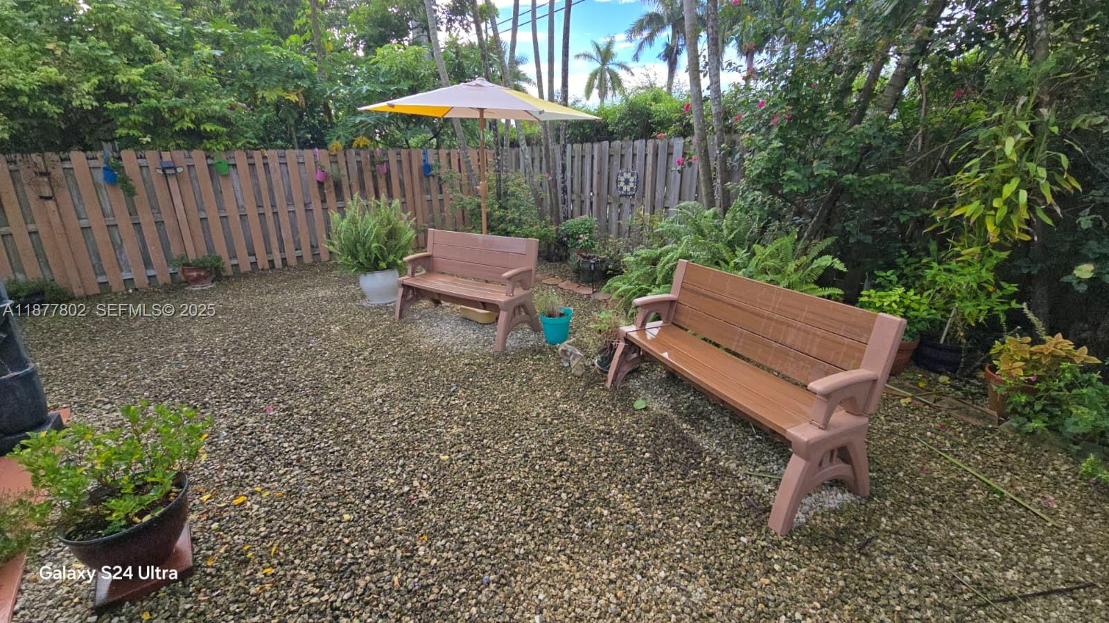 15436 Southwest 151st Terrace Miami, FL 33196 - Photo 38 of 50 a backyard of a house with table and chairs