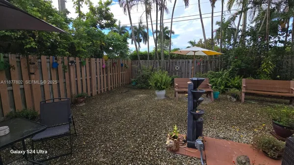 a backyard view with a seating space