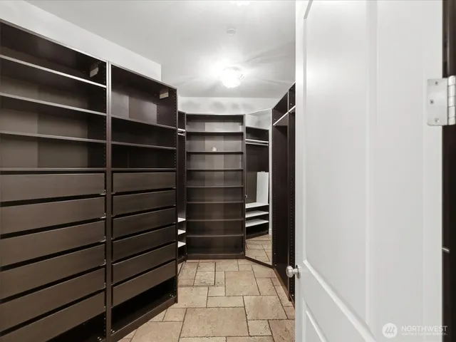 a view of walk in closet with empty racks