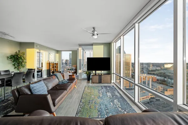 a living room with furniture tv and a large window
