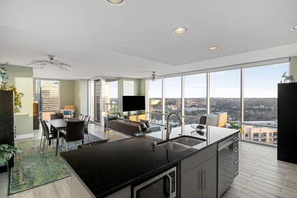 a living room with furniture large windows and a flat screen tv