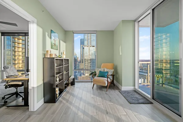 a living room with furniture and a floor to ceiling window