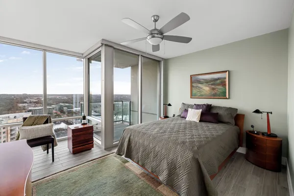 a bedroom with a large bed and a large window