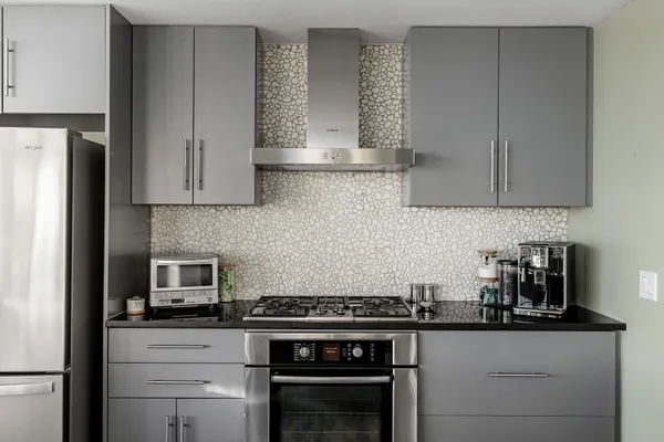 a kitchen with stainless steel appliances granite countertop a stove and a refrigerator