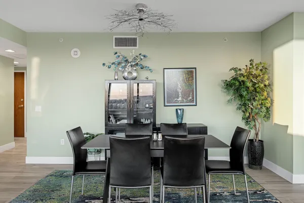 a dining room with furniture and chandelier