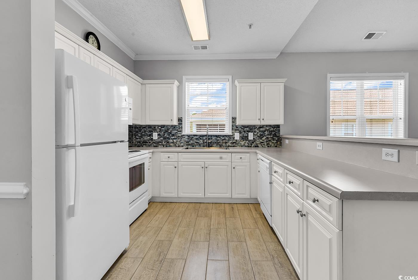 300 Kiskadee Loop, Unit K Conway, SC 29526 - Photo 2 of 40 Kitchen with white appliances, a peninsula, light