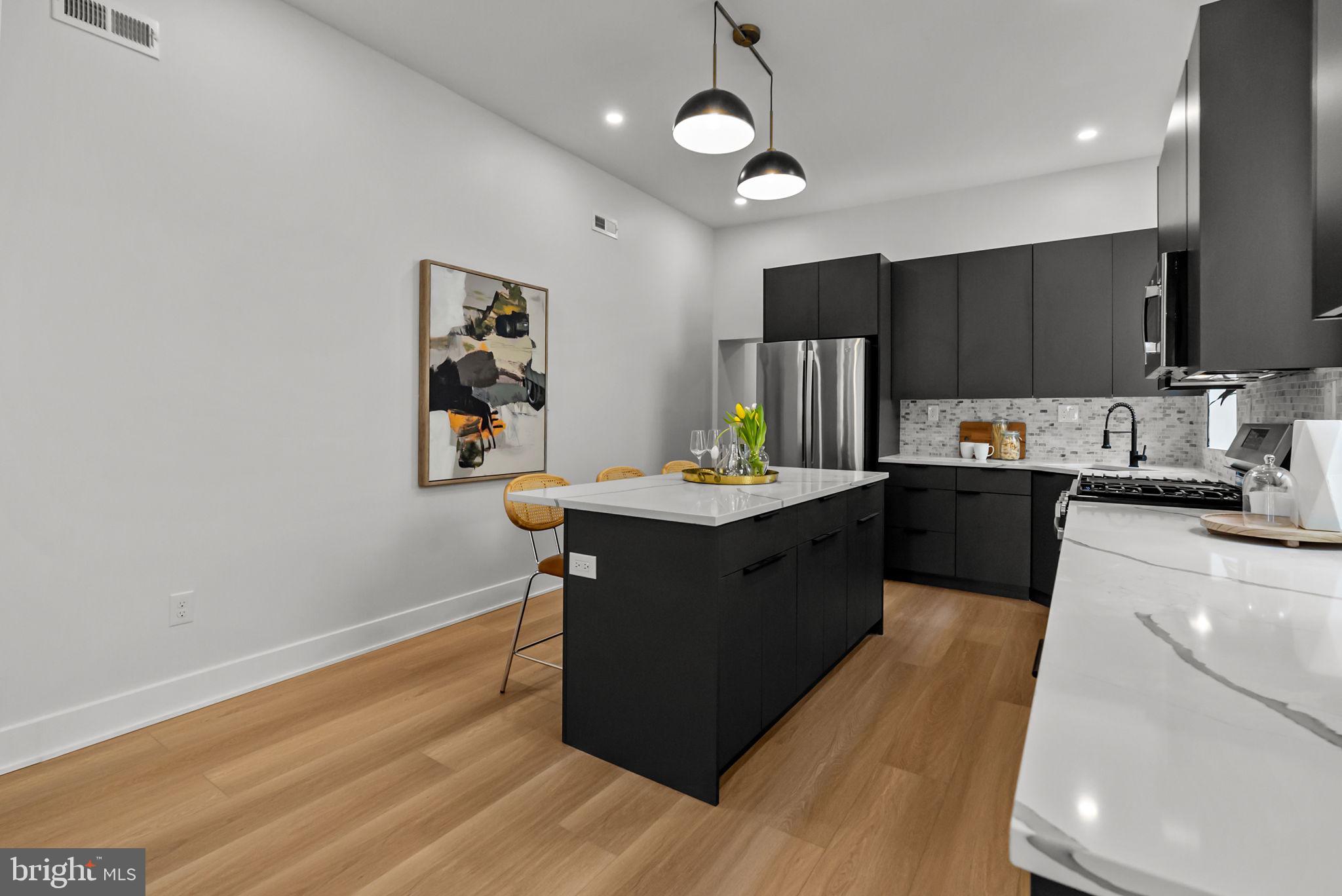 226 West Rittenhouse Street Philadelphia, PA 19144 - Photo 12 of 39 a kitchen with a sink cabinets and wooden floor