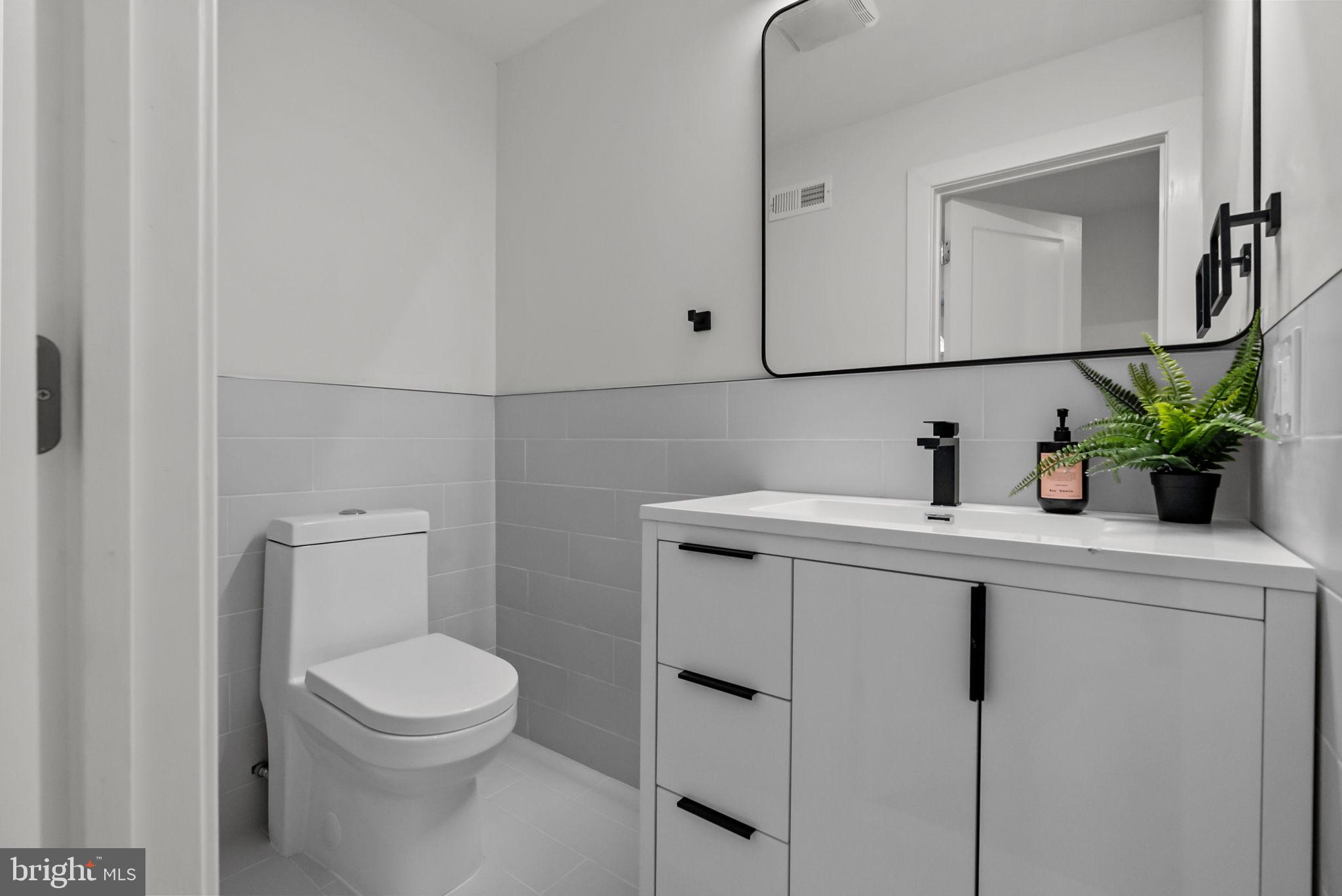 226 West Rittenhouse Street Philadelphia, PA 19144 - Photo 14 of 39 a bathroom with a toilet sink and mirror