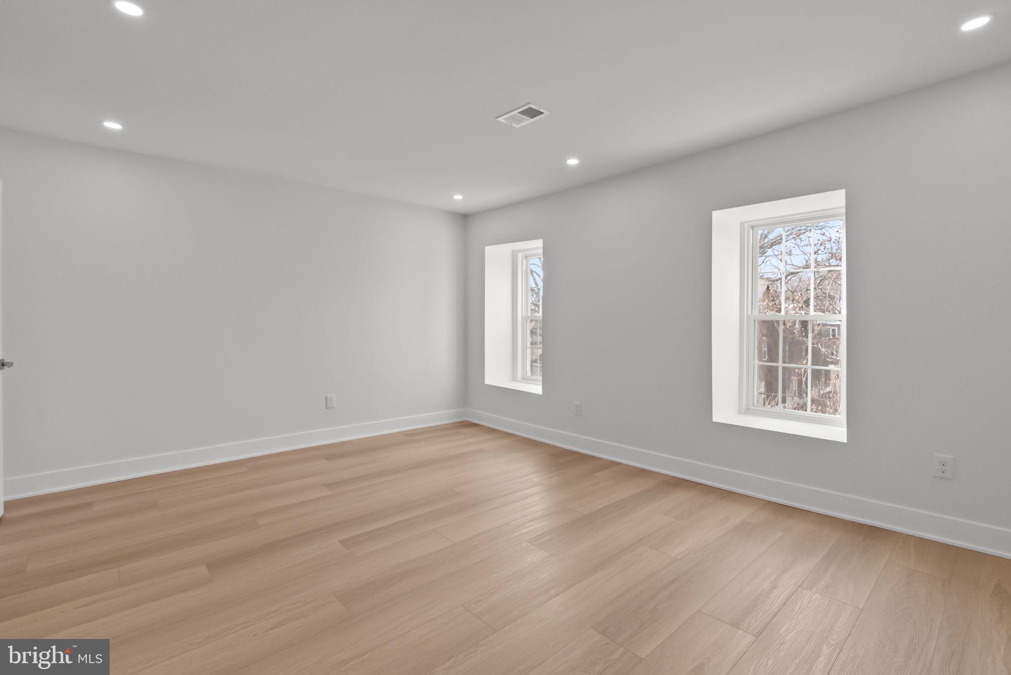 226 West Rittenhouse Street Philadelphia, PA 19144 - Photo 24 of 39 a view of an empty room with wooden floor and a window
