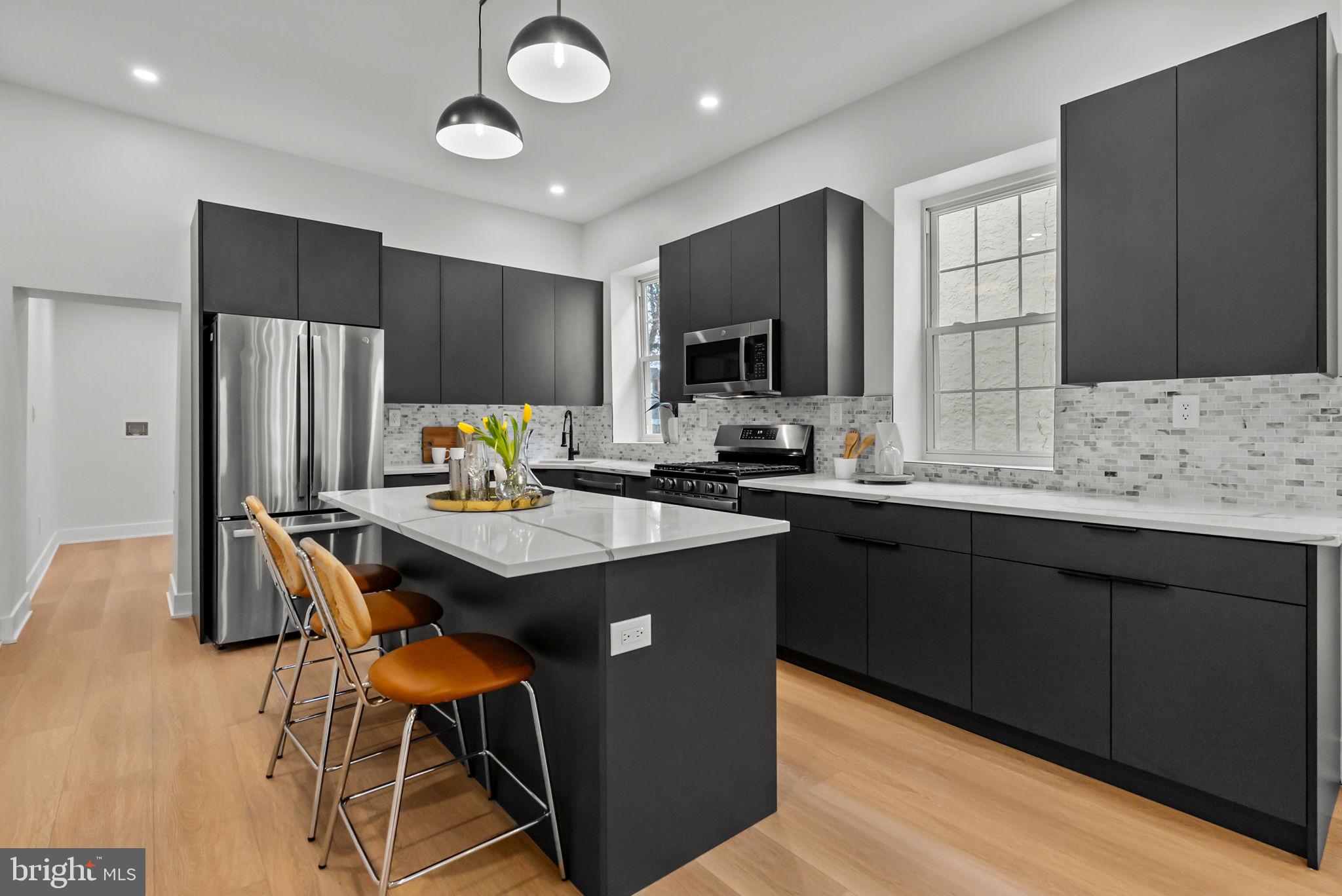 226 West Rittenhouse Street Philadelphia, PA 19144 - Photo 7 of 39 a kitchen with stainless steel appliances granite countertop a stove refrigerator sink and cabinets