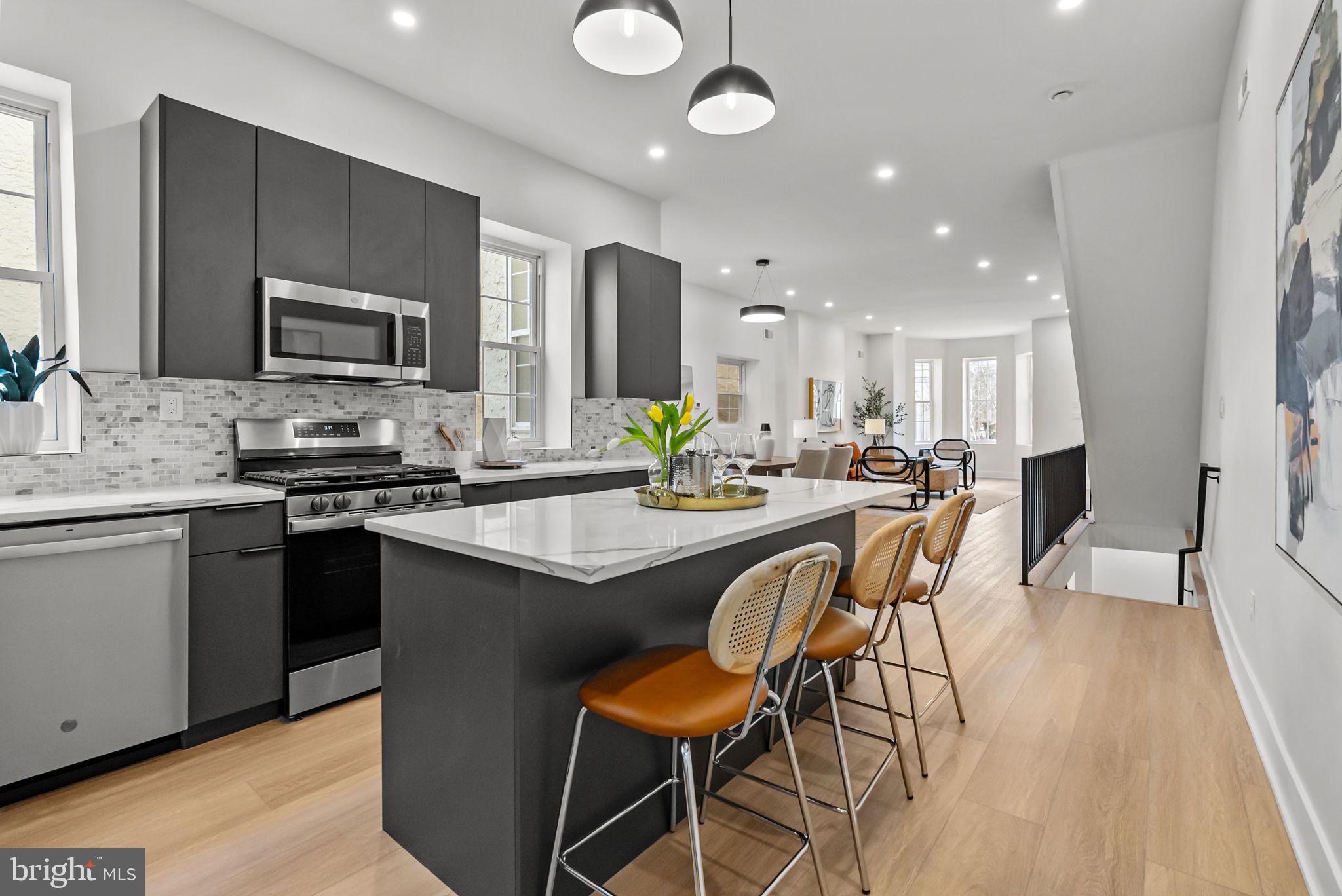 226 West Rittenhouse Street Philadelphia, PA 19144 - Photo 9 of 39 a kitchen with stainless steel appliances kitchen island granite countertop a sink and cabinets
