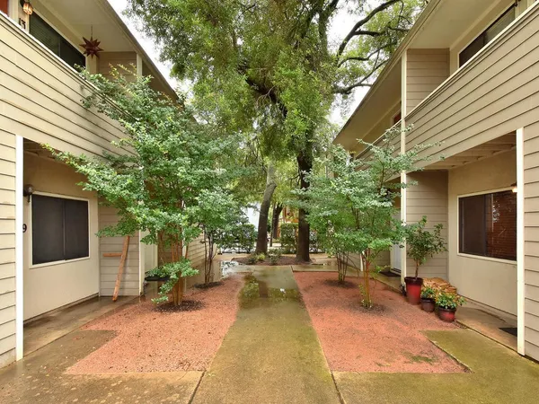 a view of a house with backyard and sitting area